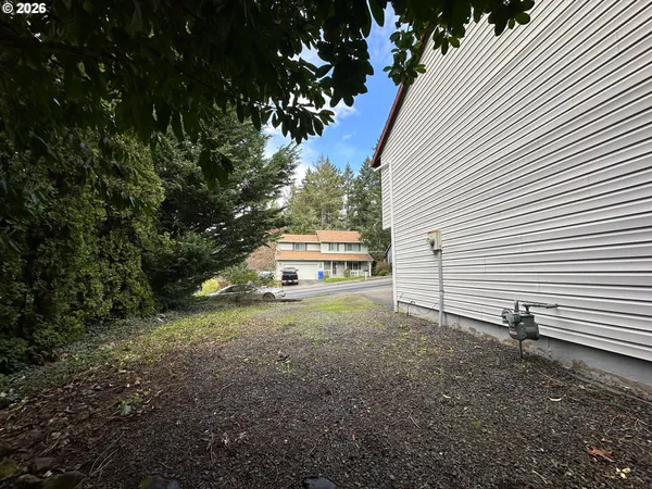 a view of a house with a yard and tree s