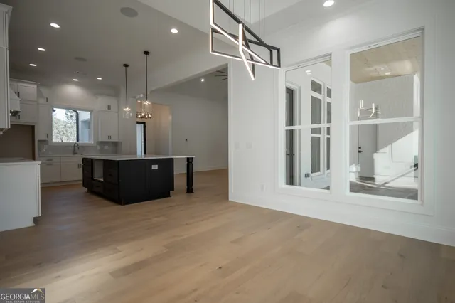 a view of a room with a cabinet and a chandelier