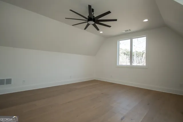 an empty room with closet and a chandelier fan