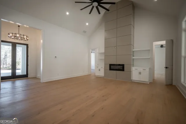 a large kitchen with stainless steel appliances granite countertop a refrigerator and a stove top oven