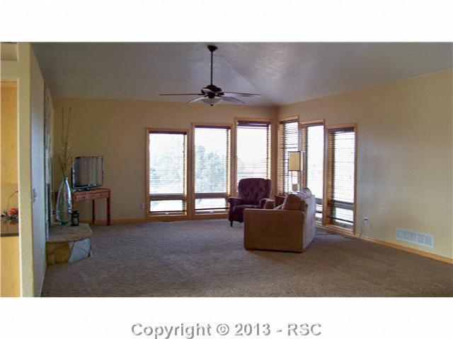 16835 Roller Coaster Road Colorado Springs, CO 80921 - Photo 16 of 25 Main Floor Living Room-Open-Bright and Spacious-Main Floor also offers a mudroom from garage with built in storage-Separate Laundry Room with Counter and Cupboard space-