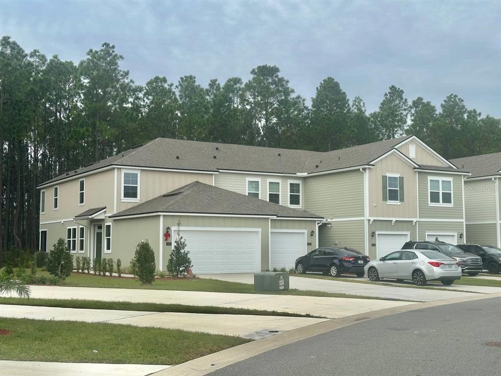 455 Redbud Road Palm Coast, FL 32137 - Photo 1 of 12 a view of a white house and a road