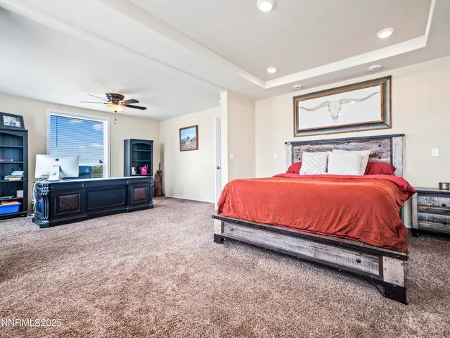 a spacious bedroom with a bed and a cabinets