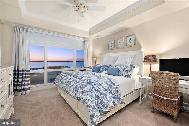 a living room with furniture and a view of kitchen