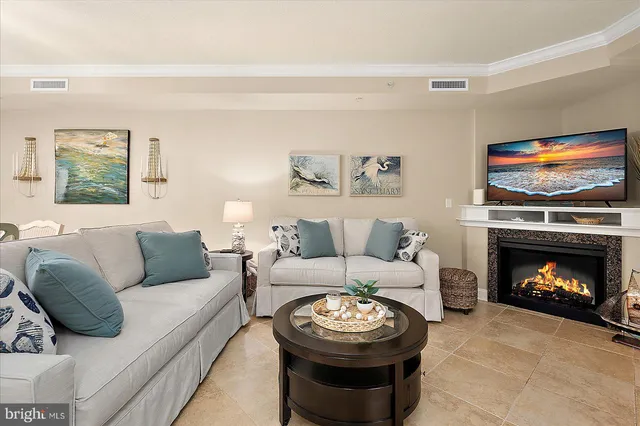 a living room with furniture and kitchen view