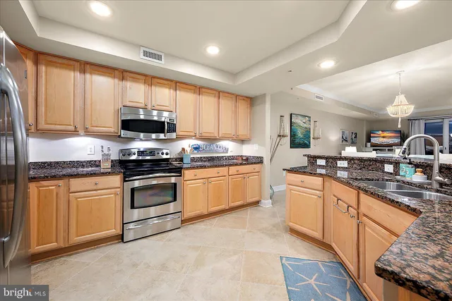 a view of a dining room with furniture a chandelier and wooden floor