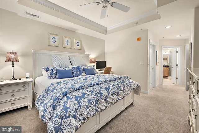 a bathroom with a granite countertop sink a mirror and shower