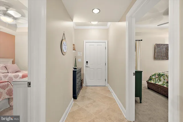 a bedroom with two beds and a chandelier