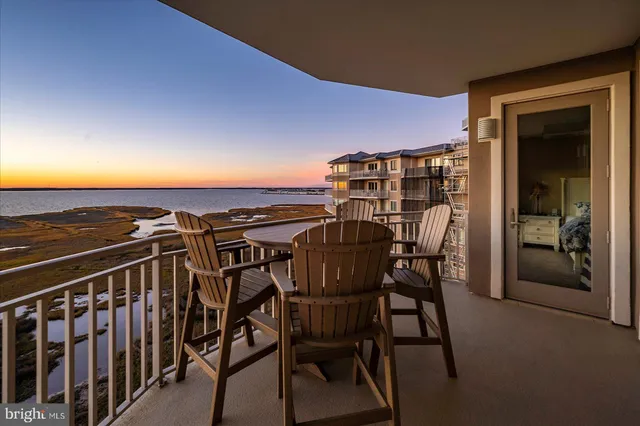 a view of a building with sitting area and furniture