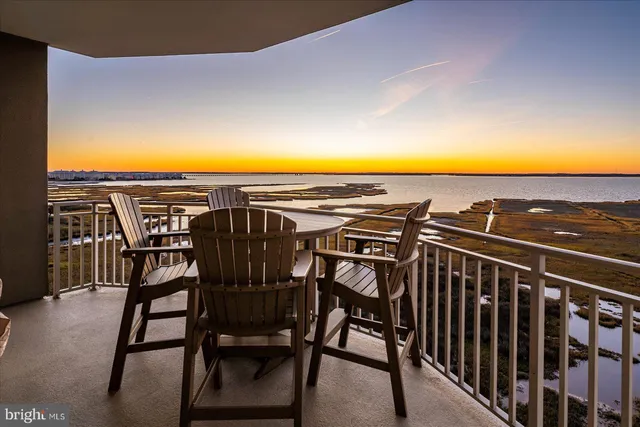 a view of a patio with a table and chairs under an umbrella