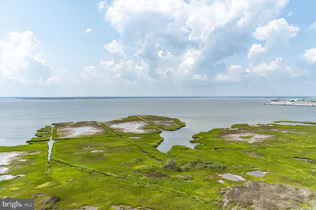 a view of a workspace with furniture and floor to ceiling window