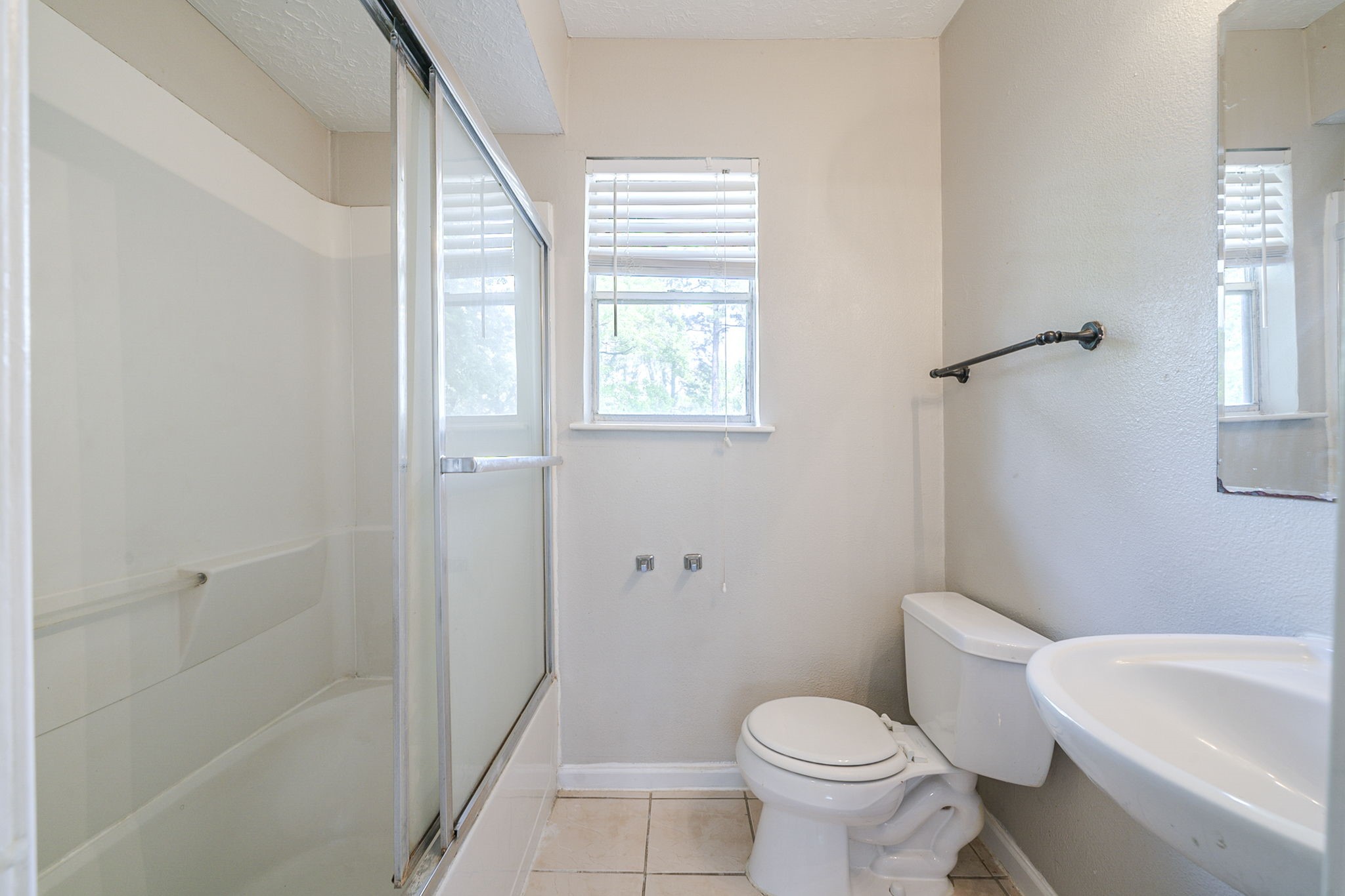 5023 Glendower Drive Spring, TX 77373 - Photo 28 of 33 a white toilet sitting next to a bathroom sink and tub