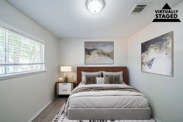 a bedroom with a bed and a window