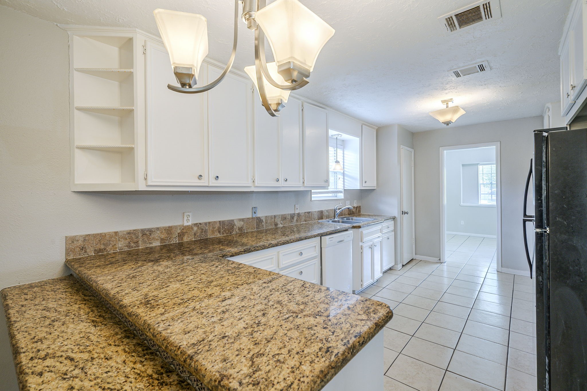 5023 Glendower Drive Spring, TX 77373 - Photo 8 of 33 a kitchen with kitchen island granite countertop a sink cabinets and stainless steel appliances