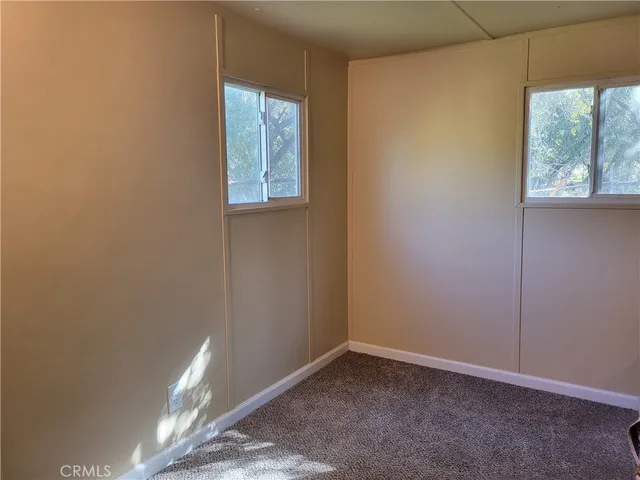a bathroom with a granite countertop toilet a sink and a mirror