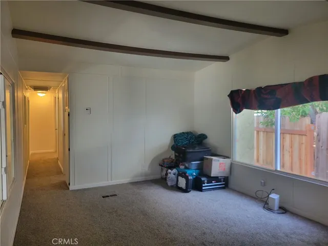 a view of room with furniture and a window