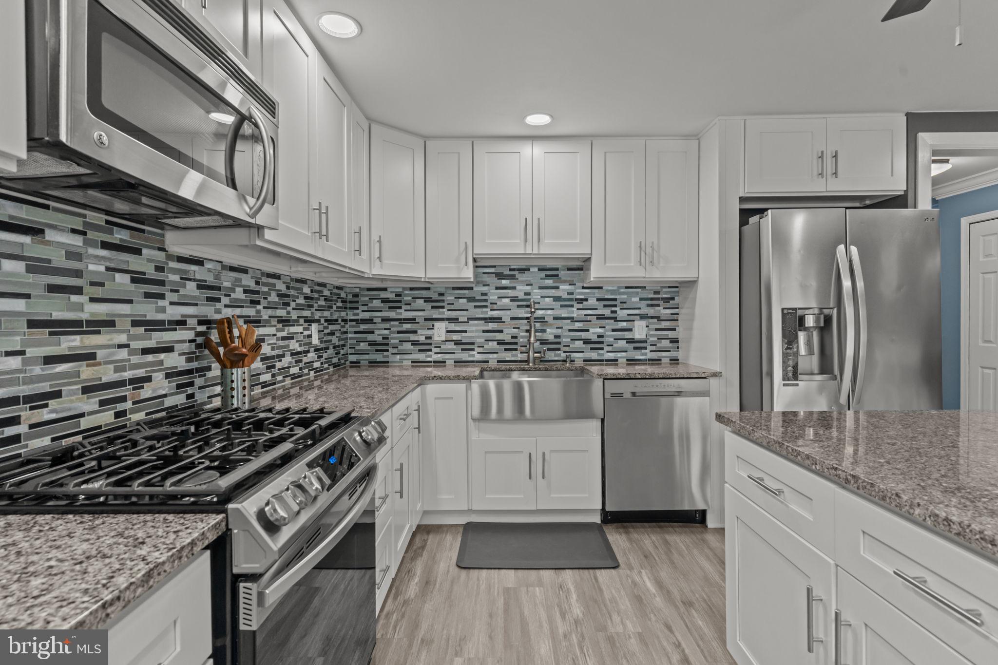 12413 Barbary Road Philadelphia, PA 19154 - Photo 13 of 29 a kitchen with white cabinets and appliances