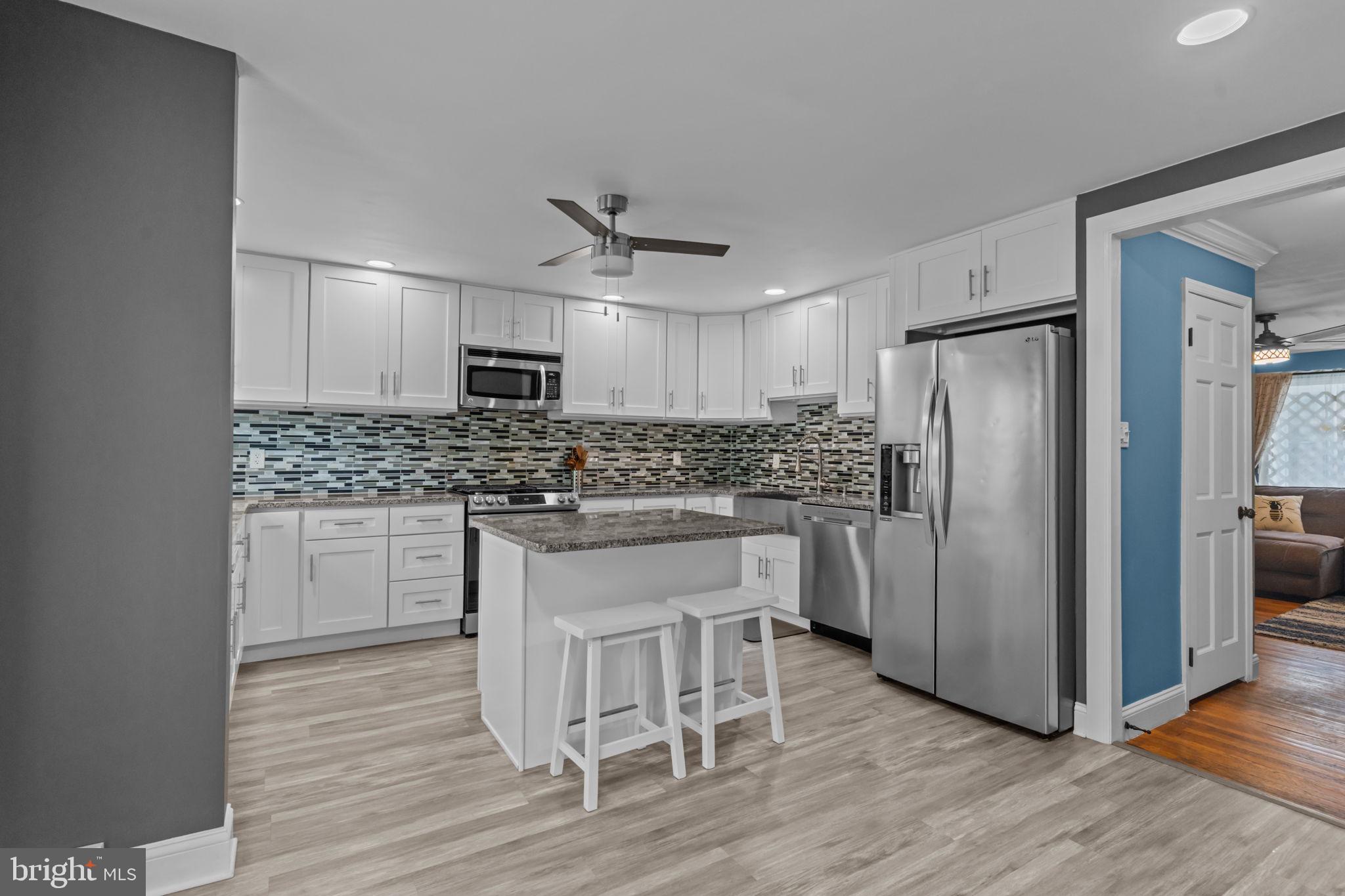 12413 Barbary Road Philadelphia, PA 19154 - Photo 10 of 29 a kitchen with a refrigerator stove and wooden cabinets