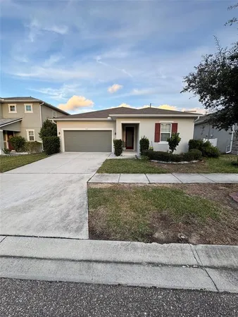 a front view of a house with a yard and a garage