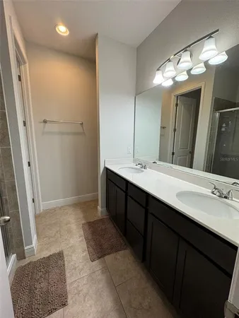 a bathroom with a double vanity sink a and a mirror
