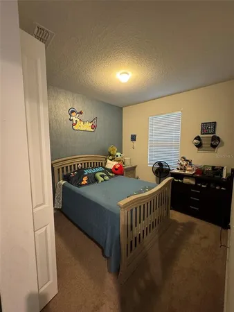 a bedroom with a bed and a dresser