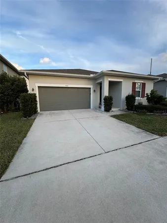 a front view of house with yard and trees