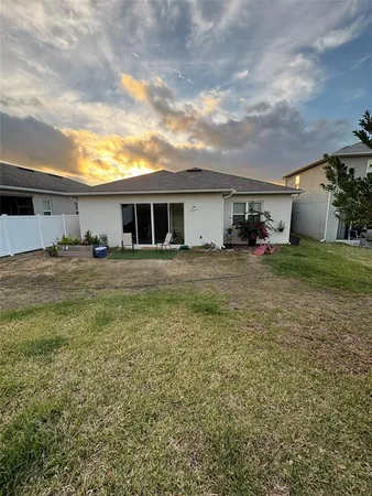 a view of a house with a yard and sitting area