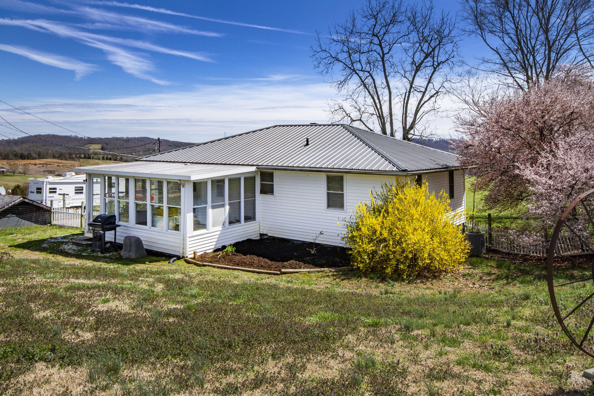 1201 Manley Road Rutledge, TN 37861 - Photo 13 of 27 a front view of a house with a garden and plants