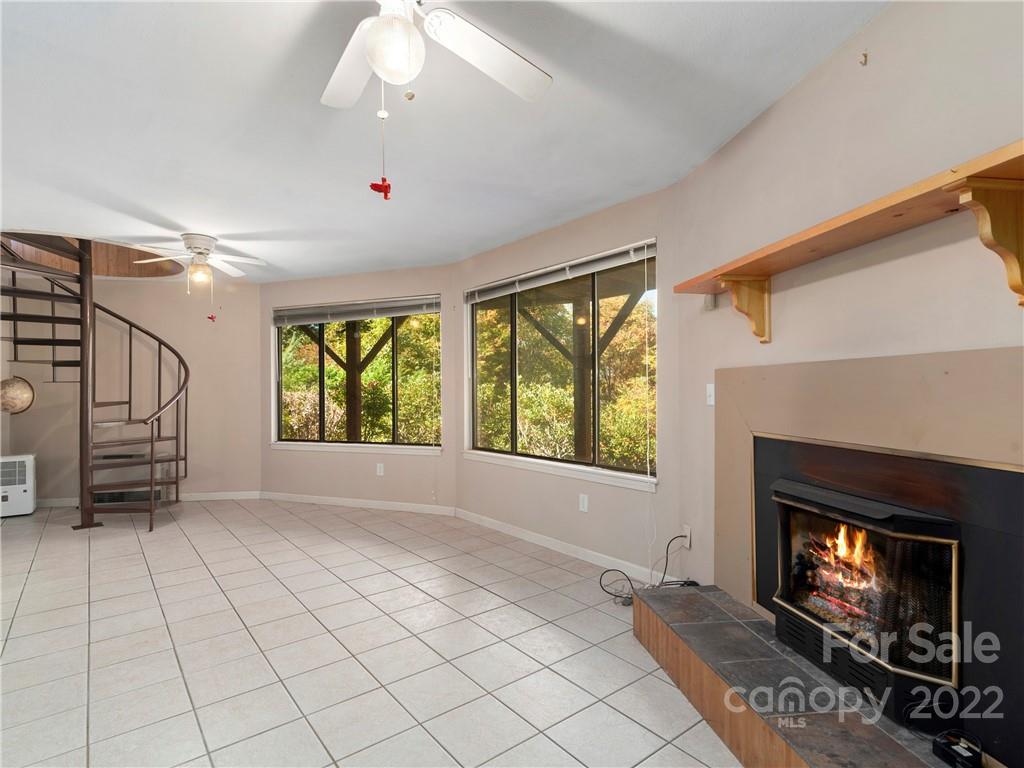 850 Mt Valley Road Waynesville, NC 28785 - Photo 17 of 22 a view of an empty room with a fireplace and a window