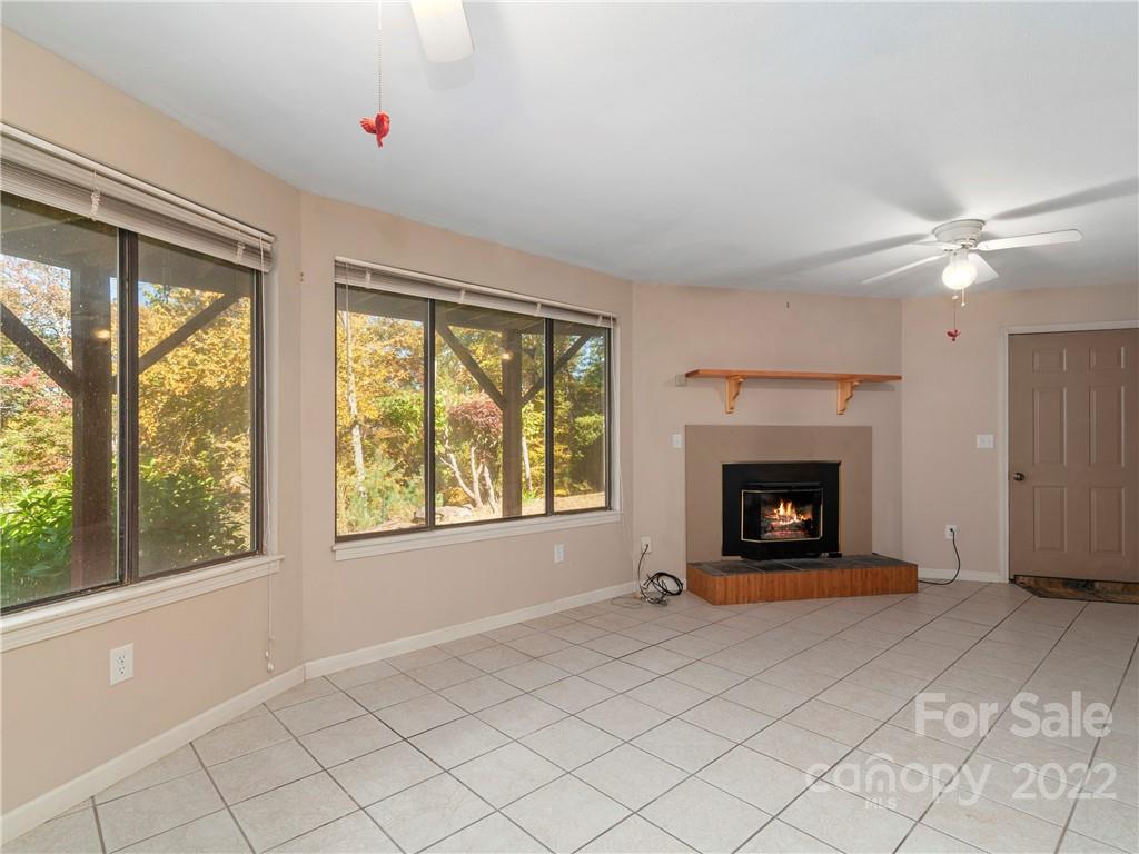 850 Mt Valley Road Waynesville, NC 28785 - Photo 18 of 22 a living room with furniture and a fireplace