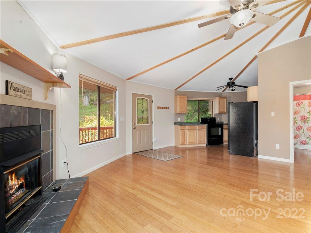 850 Mt Valley Road Waynesville, NC 28785 - Photo 8 of 22 a big room with windows and fireplace