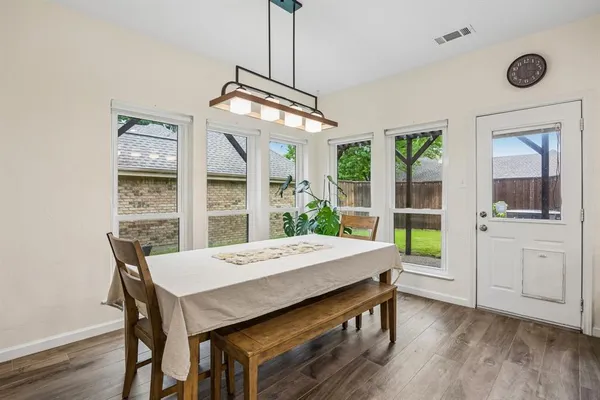 a view of a dining room with furniture window and wooden floor