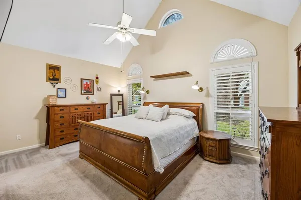 a bedroom with a bed and a chandelier