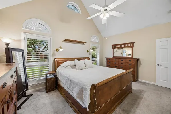 a bed room with a bed and a chandelier