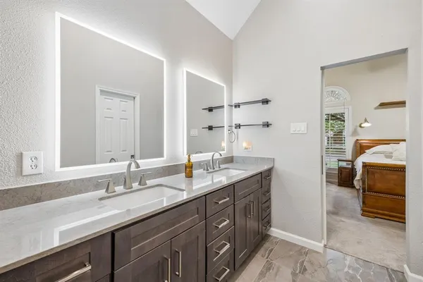 a bathroom with a sink double vanity and a mirror