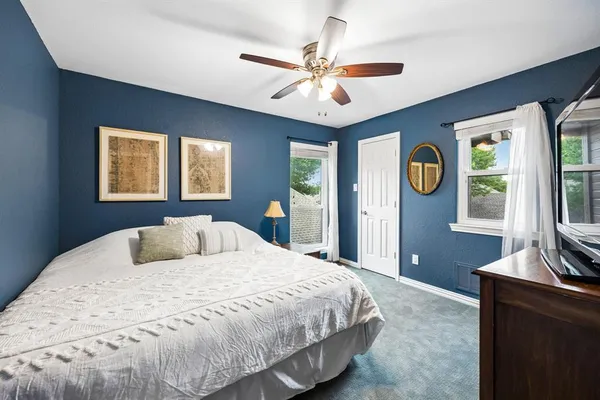 a bedroom with a large bed and a window