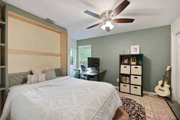 a bedroom with a bed and a chandelier