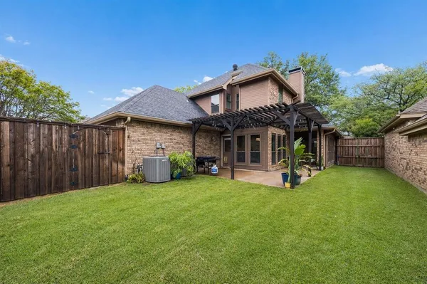 a view of a house with a yard and sitting area