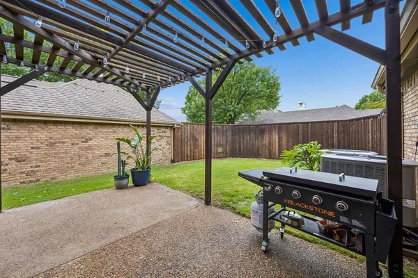 a view of a bench in back yard of a house