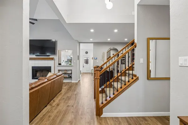 a view of a livingroom with wooden floor and stairs
