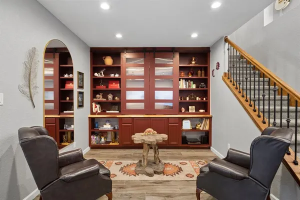a living room with fireplace furniture and a large window