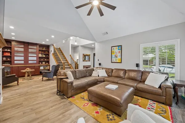 a living room with furniture and wooden floor