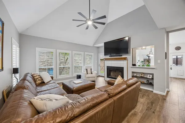 a living room with furniture a fireplace and a flat screen tv
