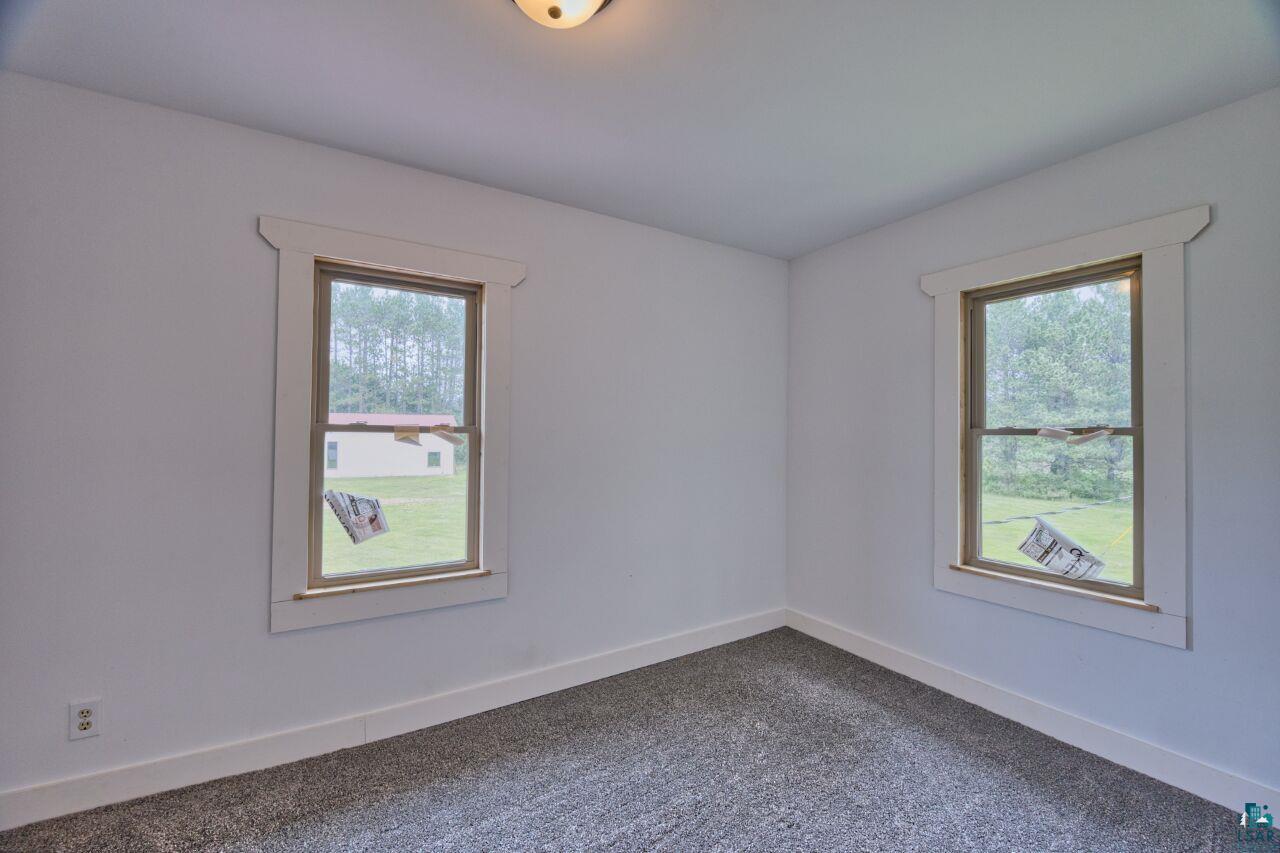 4755 Judd Road Gilbert, MN 55741 - Photo 12 of 50 Spare room with plenty of natural light, dark carpet, and baseboards
