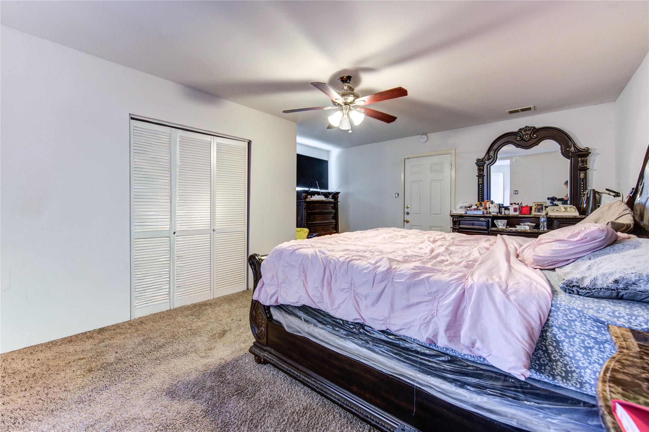1219 Pilot Point Drive Houston, TX 77038 - Photo 11 of 19 a spacious bedroom with a bed and a chandelier