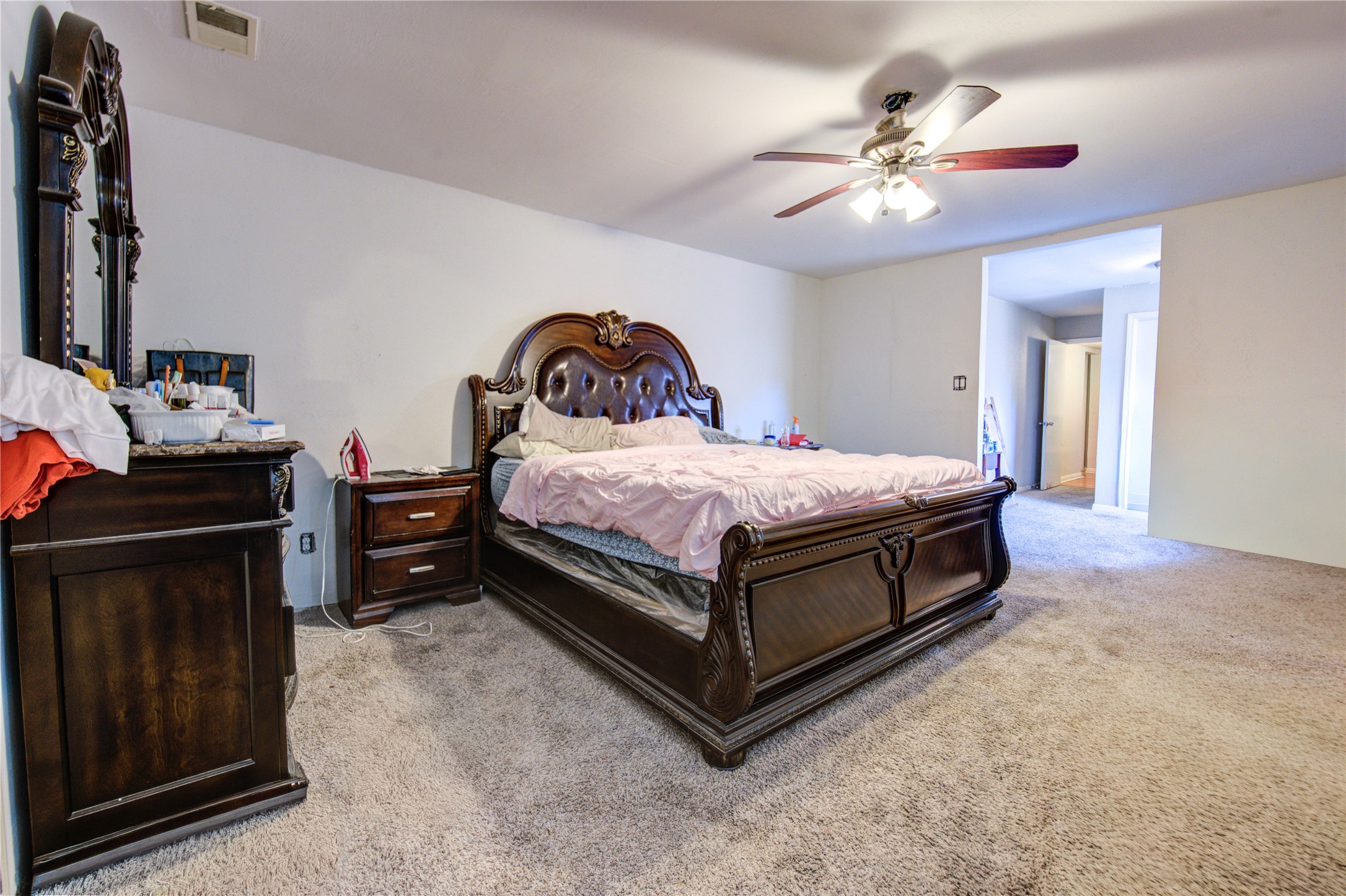 1219 Pilot Point Drive Houston, TX 77038 - Photo 12 of 19 a bedroom with a bed and a chandelier