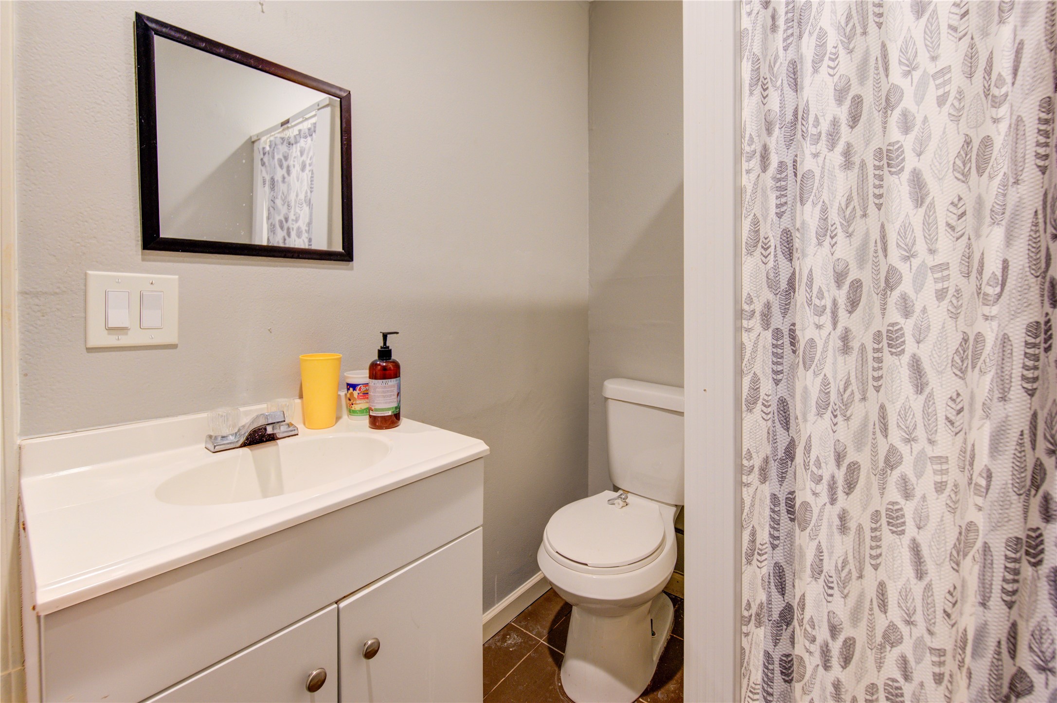 1219 Pilot Point Drive Houston, TX 77038 - Photo 19 of 19 a bathroom with a toilet sink and mirror