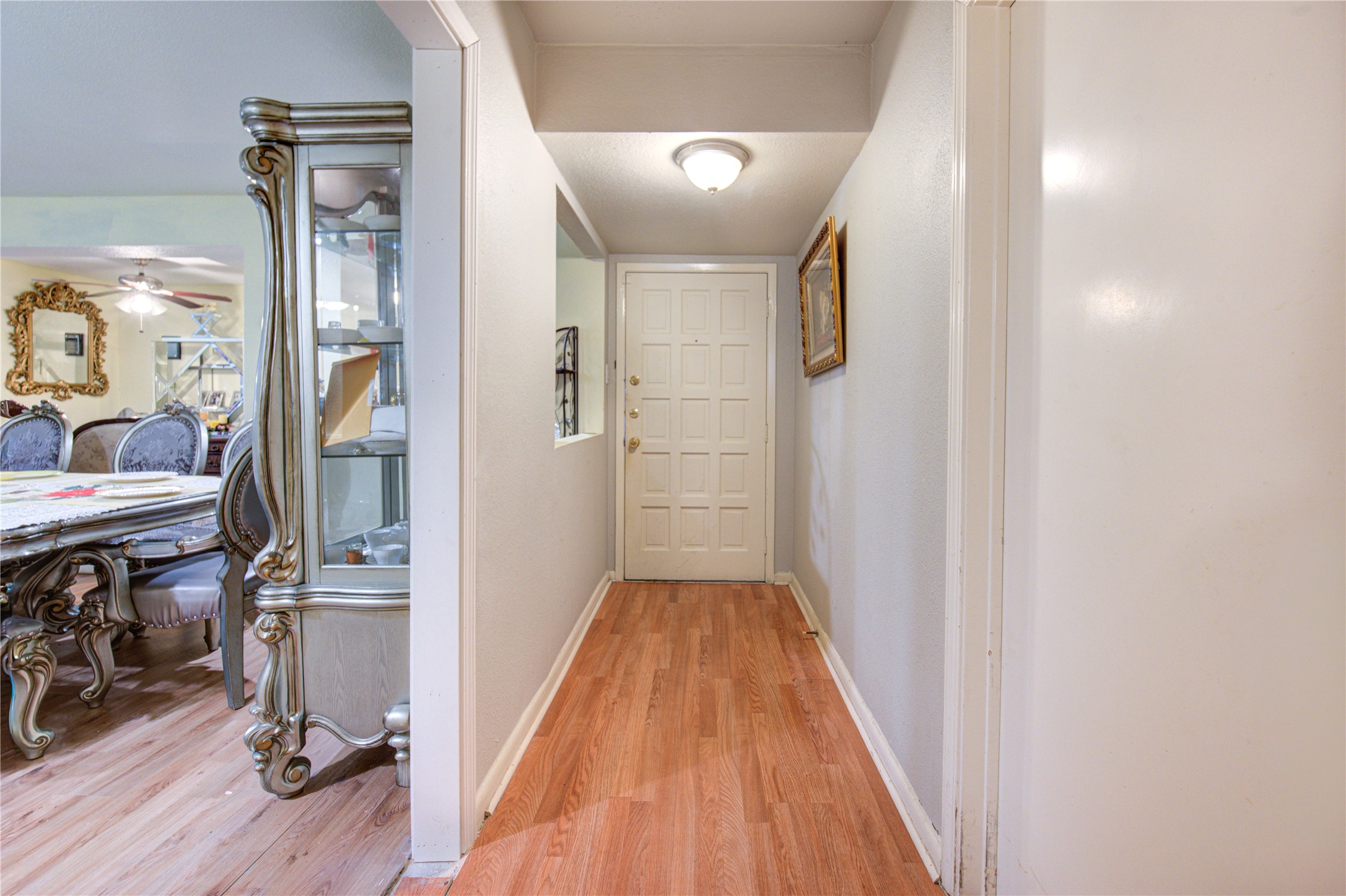 1219 Pilot Point Drive Houston, TX 77038 - Photo 3 of 19 a view of a hallway with wooden floor and entryway