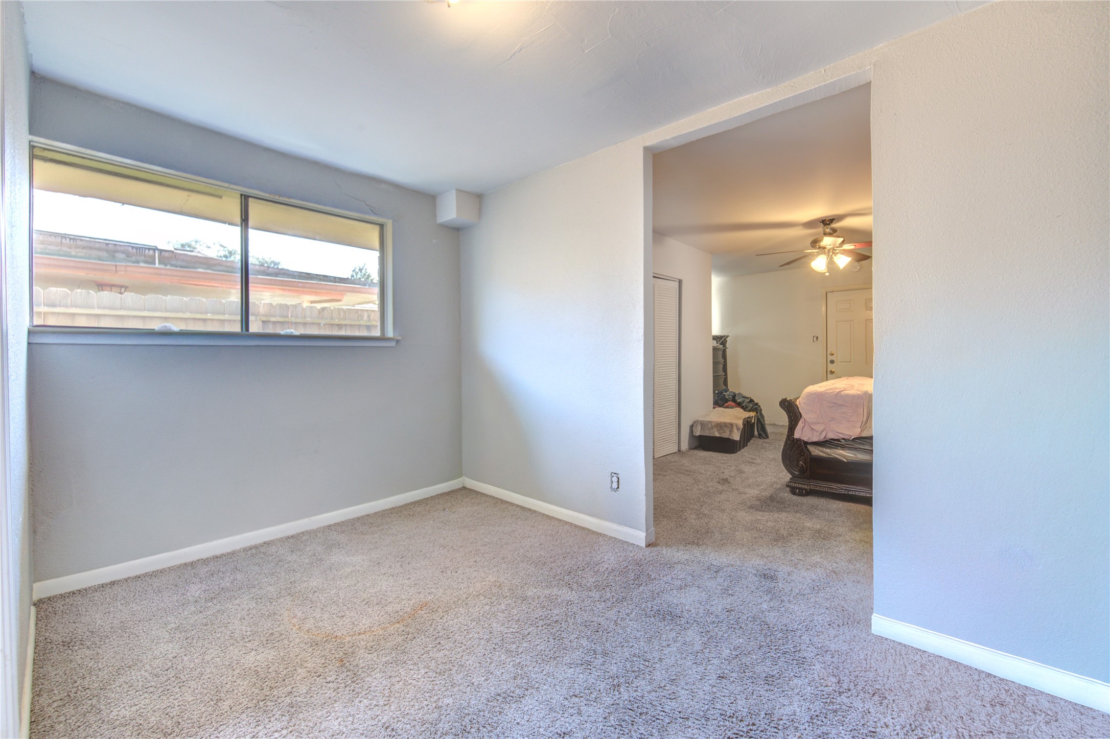 1219 Pilot Point Drive Houston, TX 77038 - Photo 10 of 19 a view of a room with a closet and a large window