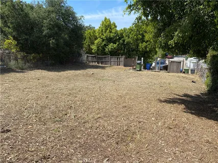 a backyard of a house with table and chairs